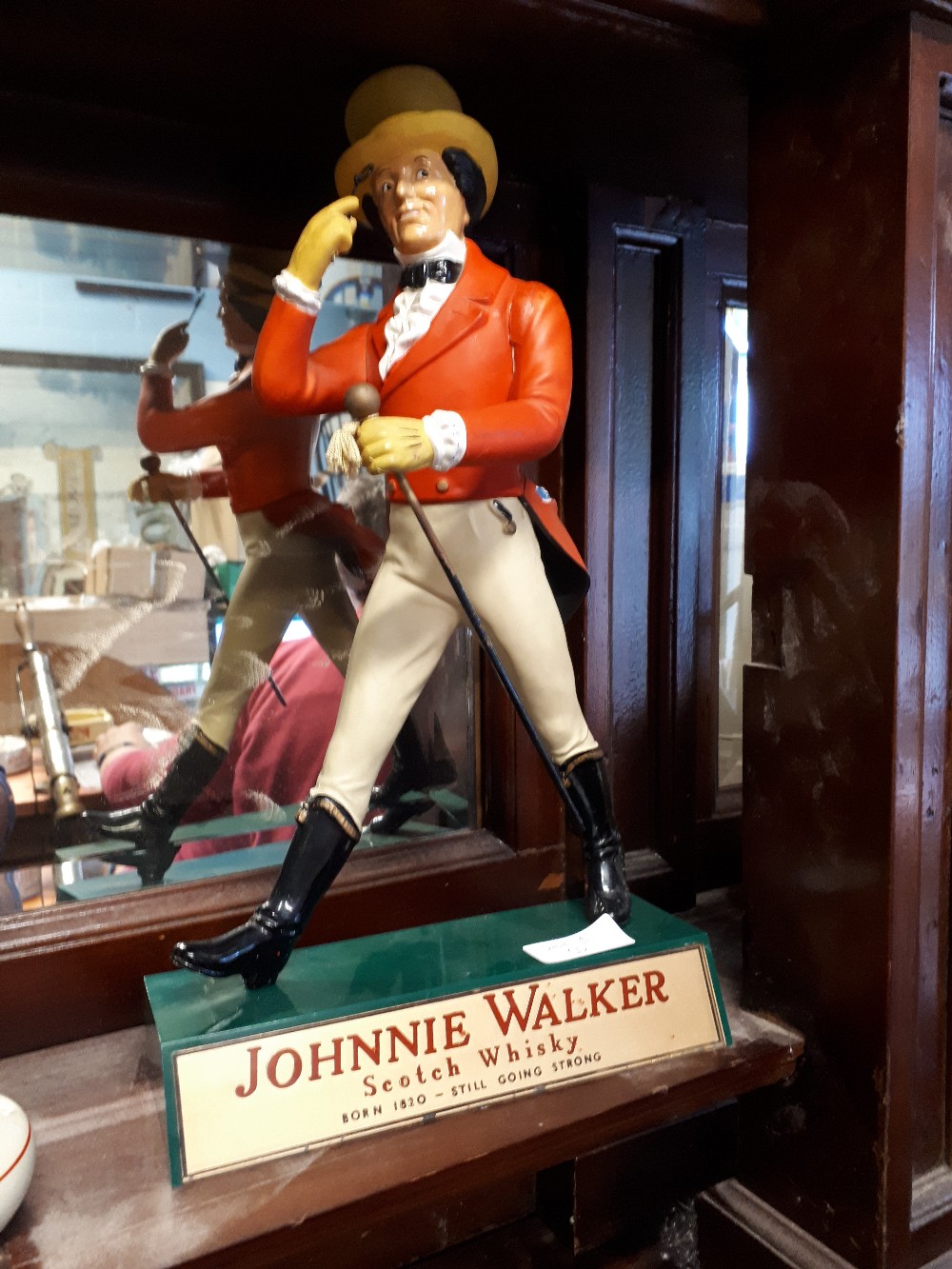 JOHNNIE WALKER Scotch Whisky advertising figure.