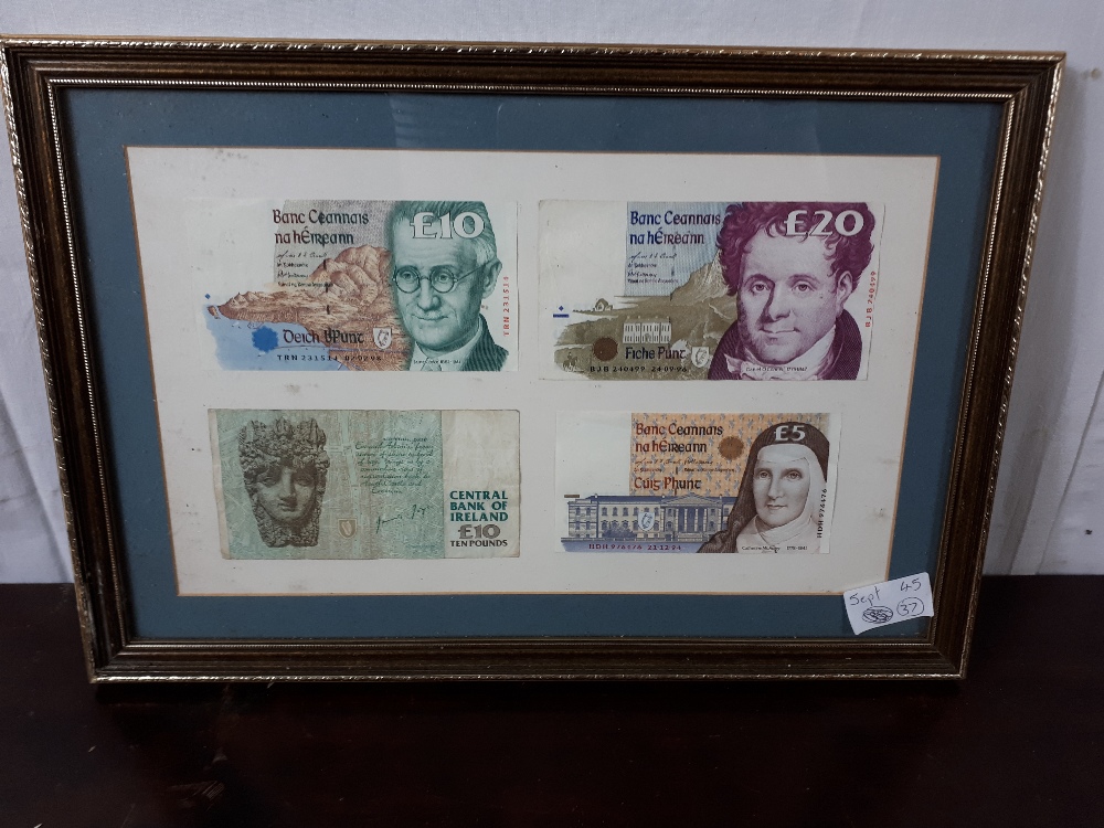 Collection of Series - C Irish bank notes mounted in a frame.