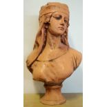 Terracotta Bust of a Young Woman with headdress, on a circular base, 21in high.