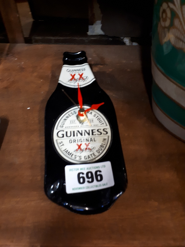 Advertising clock in the form of a Guinness bottle.