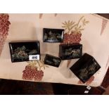 Set of five Japanese lacquered boxes with hand painted mountain scenes.