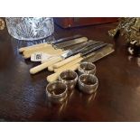 Miscellaneous lot of twelve butter knives and napkin rings.