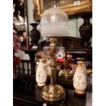 Brass oil lamp with etched globe.