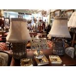 Pair of whisky jars in wicker baskets converted into lamps.