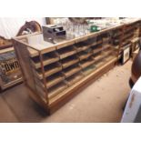 1940's Oak glazed haberdashery cabinet with a bank of 25 drawers.