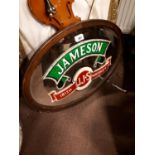 Mahogany oval mirror advertising Jameson Whiskey.