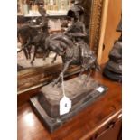 Bronze horse and rider on marble base.