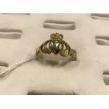 Gold Claddagh ring.