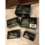 Set of five Japanese lacquered boxes with hand painted mountain scenes.