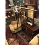 Large mahogany and brass telescope on tripod stand.