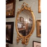 Regency gilt overmantle with two candlw esconces and rope decoration.