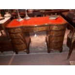 Victorian style mahogany tolled leather topped desk with shaped front.