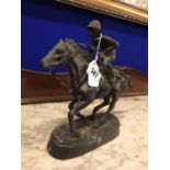 Bronze model of a horse and jockey.