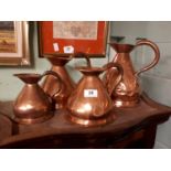 Set of four graduated copper haystack measures.