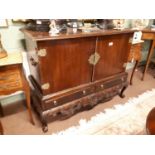 Edwardian mahogany chest on stand to incude two blind doors over two drawers resting on paw feet.