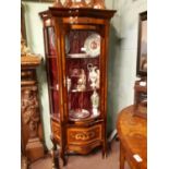 Decorative bow fronted French display cabinet with brass mounts.