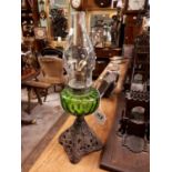 Victorian oil lamp with green glass bowl.