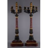 Due candelabri cinque fiamme in marmo e bronzo dorato. XIX secolo. Mis. Alt. cm. 70 ca.