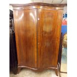 EDWARDIAN MAHOGANY AND CHEQUER STRUNG INLAID SERPENTINE DOUBLE DOOR WARDROBE WITH MOULDED DENTIL