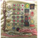 COLLECTION OF BOY SCOUT SEW-ON BADGES AND LAPEL AND CAP BADGES,