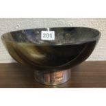 A POLISHED HORN BOWL MOUNTED ON A SILVER STAND