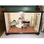 CASED INTERIOR ROOM SETTING WITH A SEATED BRIDE DOLL HEIGHT-27CM WIDTH-39.