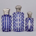 Three Silver Mounted Blue Overlaid and Cut Glass Perfume Bottles, late 19th century, largest height