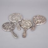 Four Edwardian and North American Silver Hand Mirrors, c.1900-10, largest length 10.4 in — 26.5 cm (