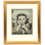 A head and shoulders studio photographic portrait of Margaret O’Brien, as a child wearing sun hat