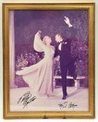 A full length sepia photograph signed “Betty Hutton” and “Fred Astaire”, showing them swirling in
