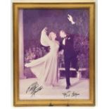 A full length sepia photograph signed “Betty Hutton” and “Fred Astaire”, showing them swirling in