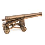 A good 19th century model cannon, the bronze barrel 10½”, on its 4 wheeled openwork brass garrison