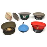 An ERII scarlet peaked cap of the 9th/12th Lancers, bi-metal badge; 2 E German peaked caps; and