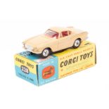 A Corgi Toys Volvo P.1800 (228). An example in light brown with red interior. Boxed, minor pen