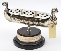 A silver plated table centre piece in the form of a Viking long ship, length 11”, with dragon head