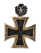 A 1939 Knight’s Cross with oak leaves, being an unmarked nickel silver example with iron centre, the