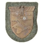 A Third Reich Krim shield, on field grey patch with paper backing. GC unissued (small patch of