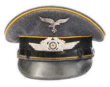 A Third Reich Luftwaffe Flight Section NCOs peaked cap, with metal insignia, golden yellow piping,
