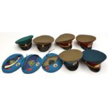 A quantity of Russian post WWII headgear, comprising: 6 dress peaked caps complete with chinstraps