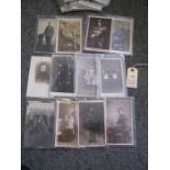 14 WWI monochrome postcards of individuals, mostly infantry men in service dress; 4 of family groups