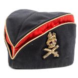 A General officer’s tent cap, c 1895, of blue and scarlet cloth with gilt piping, embroidered