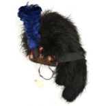 A Highland feather bonnet, two tails, diced red, white and blue wool headband, black silk tassels,