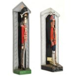 2 painted wooden doorstops, in the form of painted stylized figures in sentry boxes, 23rd Regt