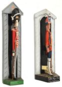2 painted wooden doorstops, in the form of painted stylized figures in sentry boxes, 23rd Regt