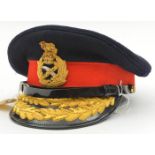 A post 1953 general officer’s peaked cap, blue body, red band, gilt bullion badge and peaked