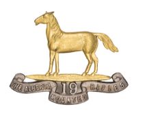 An officer’s gilt and silver plated cap badge of the 19th Alberta Mounted Rifles, GC. Plate 5 Part I