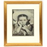 A head and shoulders studio photographic portrait of Margaret O’Brien, as a child wearing sun hat