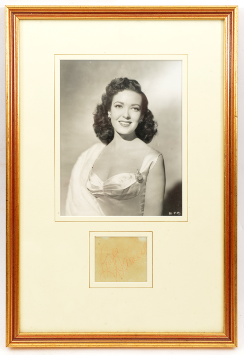 A waist length studio photographic portrait of Linda Darnell, mounted and framed, with inset