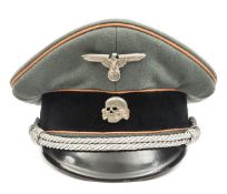A Third Reich SS officer’s peaked cap, with faded orange piping for Feldgendarmerie and silver