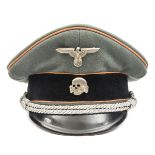 A Third Reich SS officer’s peaked cap, with faded orange piping for Feldgendarmerie and silver